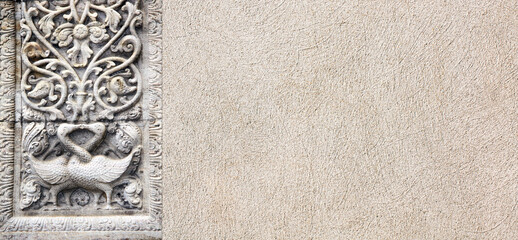 Horizontal background with stone bas-relief with two kissing swans and floral ornament. Backdrop with sandstone carving decor. Mock up template. Copy space for text