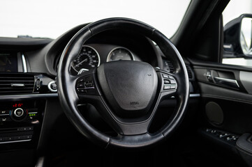 Fototapeta premium Modern car interior steering wheel controls