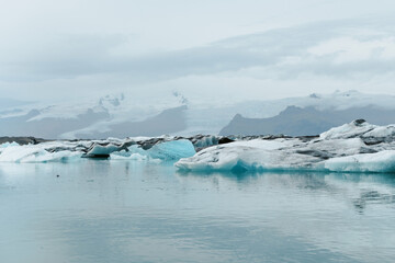 Cold arctic environment floating icebergs and snow covered mountains