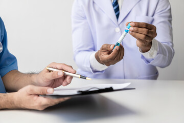 Provide medical consultation Doctor talking with patient in clinic office Focus on the hand and stethoscope Doctor and patient sit and talk with patient about medication. At the table by the window