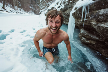 young happy man bathes in winter in an icy river in nature