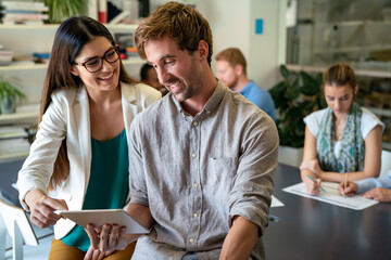 Happy business people, office colleagues having discussion during meeting in conference room.