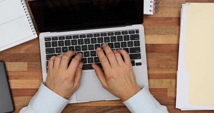 Businessman opened laptop and started working in office top view