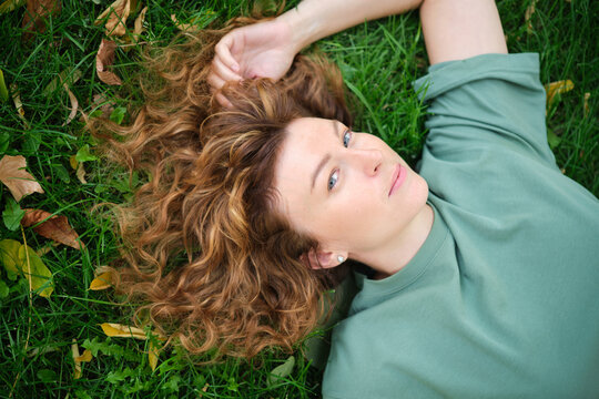 Portrait of happy mature woman looking at camera. Successful proud woman in city street at sunset. Satisfied Caucasian woman in formal clothing smiling outdoors. High quality photo