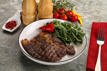 Grilled chuck roll steak with arugula