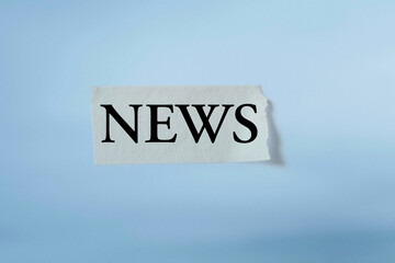 Masking tape with the word News isolated on blue background.