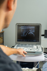 close-up of an ultrasound seen from the shoulder of a physiotherapist