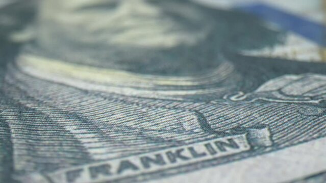 Macro elegance: This 360 degree close-up showcases the beauty of a one hundred-dollar bill's texture and artistry. Debt and assets concept. Cash money Background. 4K.
