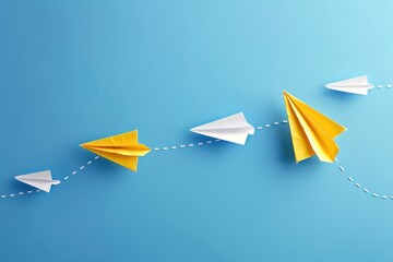 Change concepts with yellow paper boat leaving a dotted line on blue background leading among white airplane group stock photo 