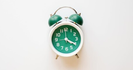 A classic alarm clock counts down time - the hands make a full circle at the 12 o'clock position. Stop motion animation 4K