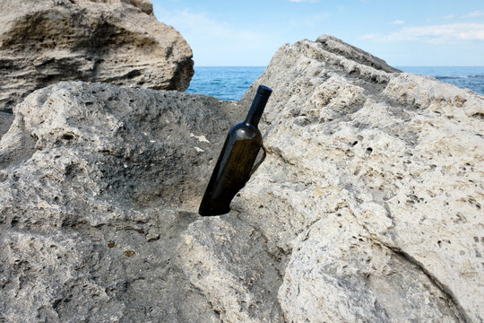 Bottle of wine in the rocks.