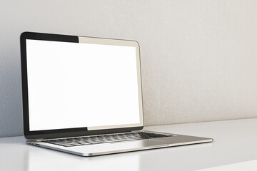 Fototapeta premium Contemporary designer office interior with white mock up laptop. Concrete wall background. Workplace and close up concept. 3D Rendering.