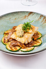 white fish with zucchini and sauce