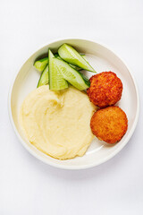 mashed potato with cutlets and cucumbers