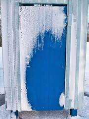 snowy blue beach hut in Nallikari, Oulu Finland