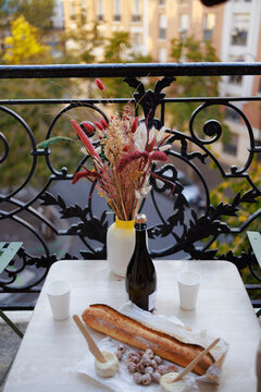 Vase with wine bottle and food in balcony