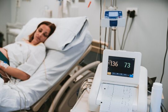 Monitoring equipment near pregnant woman lying on bed in hospital