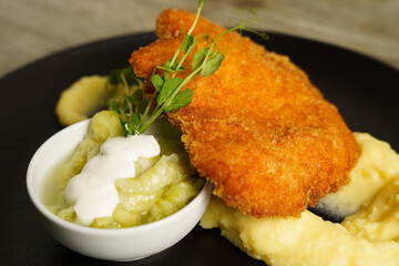 Schnitzel, Fried Chicken with Cucumber salad and mashed potato
