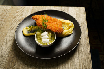 Schnitzel, Fried Chicken with Cucumber salad and mashed potato