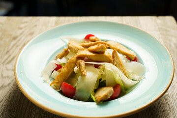 Caesar salad with grilled chicken stripes and cheese