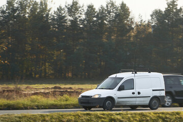 Design your own delivery service with this mockup of a white van. A blank wrap for you to customize with your business logo and name. A commercial vehicle isolated on the road with different views.
