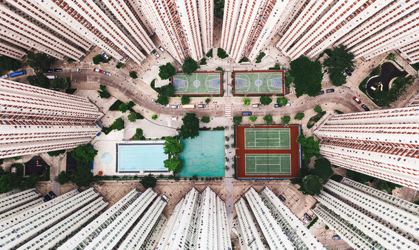 Sports courts with swimming pool near tall buildings in Hong Kong city
