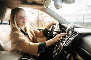 Smiling woman using GPS in car