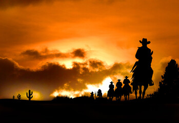 Fototapeta na wymiar Silhouette 4 Cowboys auf Pferden bei Sonnenuntergang - Wester Wildwest Tradition - Amerika USA