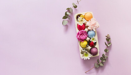 Colorful Easter eggs decorated with flowers over pink background