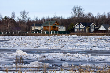 Fototapeta na wymiar A landscape of an ice drift (ice-boom, debacle) on the northern river, flood plain forest. Rivers of the Lake Ladoga basin, Northeast Europe