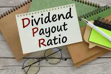 Business different notepads on the table. text on the page near the glasses Dividend payout ratio.