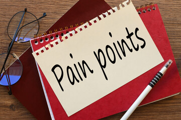 PAIN POINTS text on wooden block on chart background , business concept