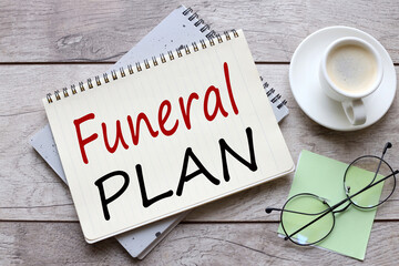 Funeral Plan glasses on a green sticker. text on notepad page