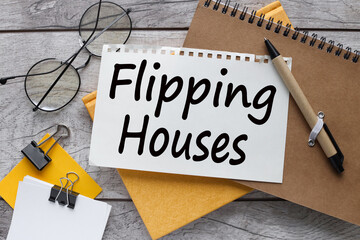 Flipping Houses text on the page. pen points to text - obrazy, fototapety, plakaty