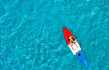 Aerial view of a kayak in the blue sea .Woman kayaking She does water sports activities	