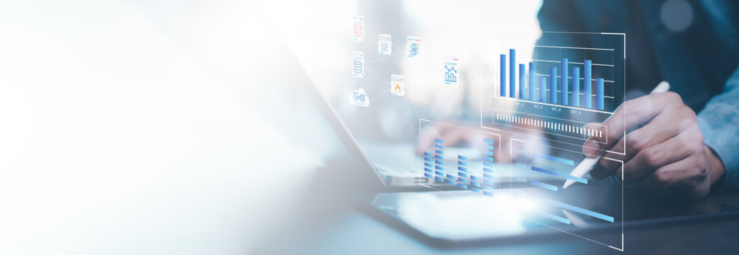 Businessman using computer for development and Analytics Data technology management System for report marketing strategy planning. graph analysis and information on a futuristic virtual screen.