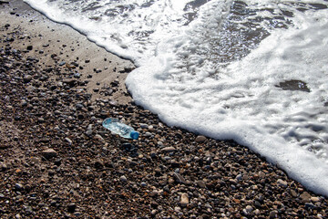 empty water bottle thrown on the beach