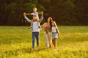 Family enjoying summer weekend and spending time in nature. Happy mother, father and little...