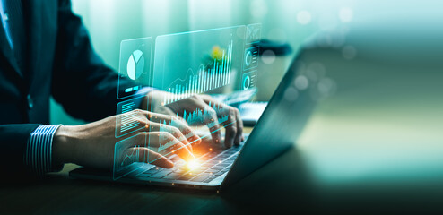 Businessman using laptop and analyzing economic growth, financial graph and business investment. planning strategy, stock market statistics, stock market trends, technical analysis strategy, value