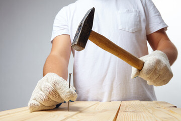 man with hammer and nail