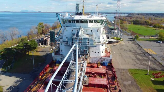 aerial of Great Lakes ore bulk lake freighter carrier while passing through locks on the northern Great Lakes