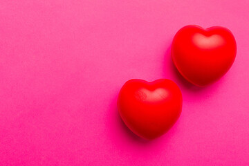 Fototapeta premium red heart shape on colored background. minimal concept top view with copy space