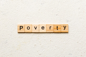 Poverty word written on wood block. Poverty text on cement table for your desing, concept