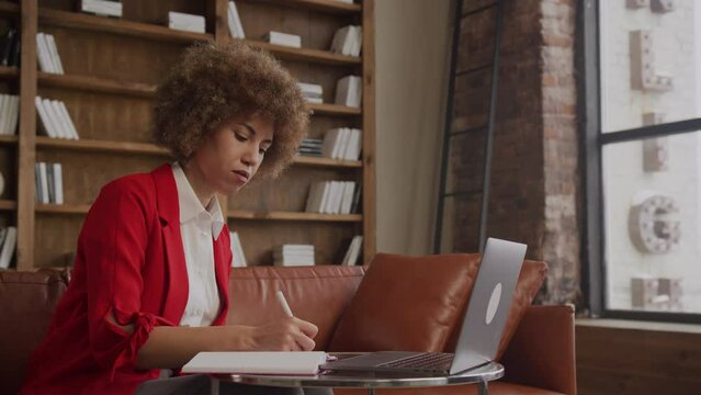 Woman Making Notes Watching Online Education Class