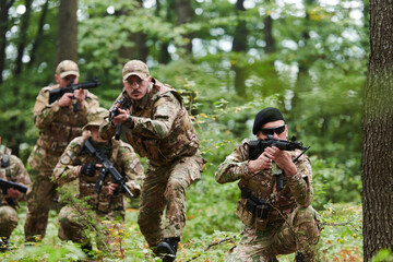 A disciplined and specialized military unit, donned in camouflage, strategically patrolling and...