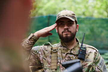 A dedicated soldier salutes his elite unit, showcasing camaraderie and readiness for the most...