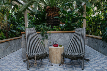 Close up of lounge wooden chairs and side table in wellness center. Wellness weekend in spa.
