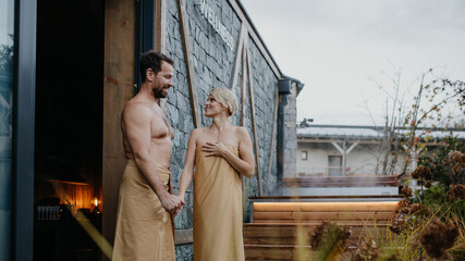 Beautiful couple standing in hotel wellness, enjoying romantic weekend in spa. Concept of...