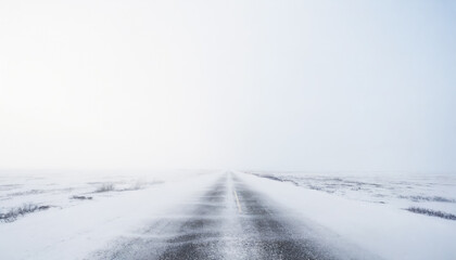 Fototapeta premium Icy road to nowhere, white winter landscapem with empty street