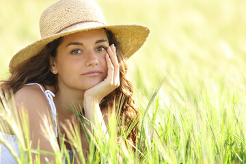 Serious woman looking at you in a field